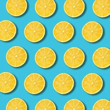 Lemon slices pattern on vibrant turquoise color background Stock Photos
