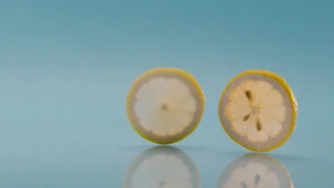 Lemon slices run on blue background for summer fresh tonic and soda juice 스톡 동영상 159290615