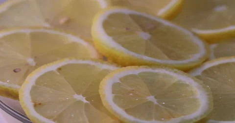 Lemon slices spin on a transparent plate. Stock Footage 130383316