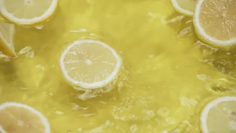Lemon slices splashing on yellow background. Freshness and hydration. Pabulum. Stock Footage 286872072