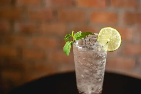 Lemon soda. Beverage for summer with brick wall background. Stock Photos
