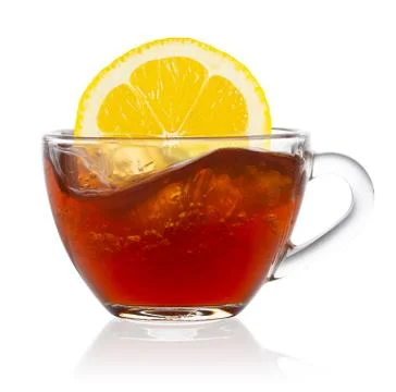 Lemon splash in transparent cup of tea Stock Photos
