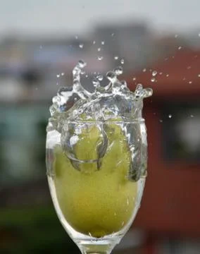 Lemon splash in water isolated in multi color background Stock Photos