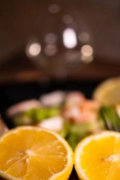 A lemon split in half in front of a fish dish Stock Photos