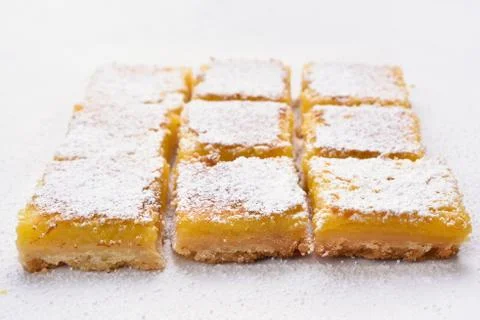 Lemon squares on baking paper Stock Photos