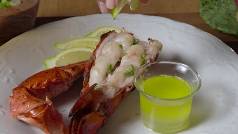 Lemon Squeeze Over Lobster Tail Stock Footage 243570102
