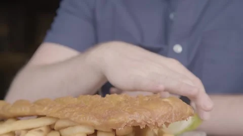 Lemon Squeezed Over Battered Fish and Chips at Restaurant Table in Sydney Stock Footage 345676044