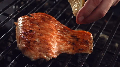 Lemon is squeezed on salmon Stock-Footage 61664375