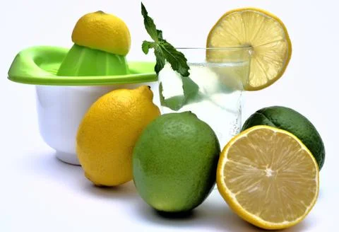 Lemon squeezer with lemon and lime juice with natural menta Stock Photos