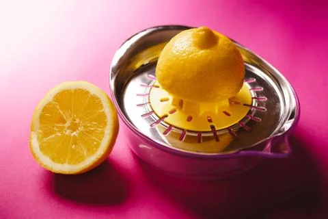 Lemon squeezer on pink background Stock Photos