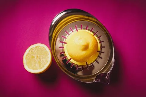 Lemon squeezer on pink background Stock Photos