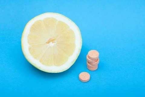 Lemon with stack of orange pills Stock Photos
