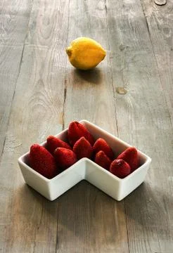 Lemon with strawberries Stock Photos