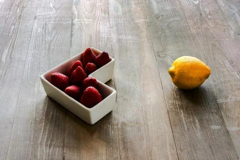 Lemon with strawberries Stock Photos