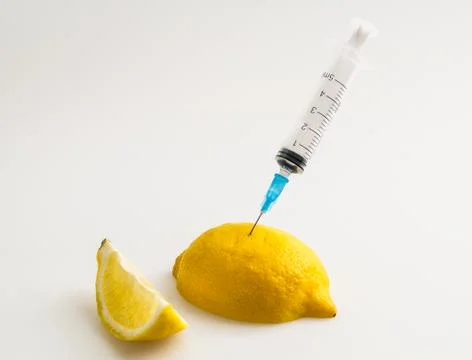 Lemon with syringe Stock Photos