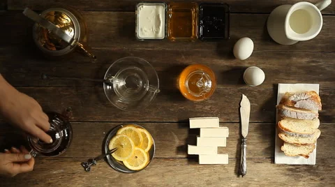 Lemon tea and fruit candy on wooden table. Stock Footage 63175117