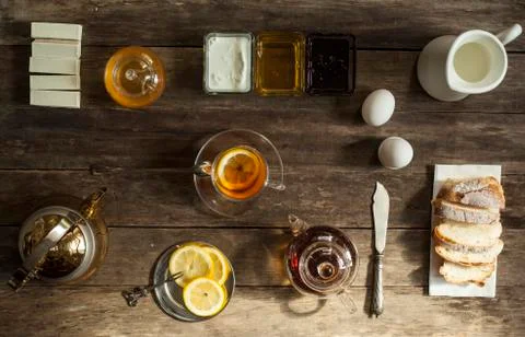 Lemon tea and fruit candy on wooden table. Stock Photos