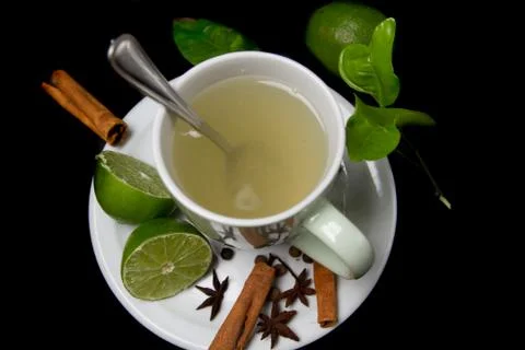 Lemon tea beverage with lemon spices on black table background zenith view Stock Photos