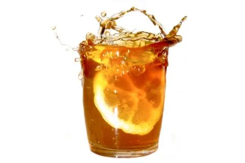 Lemon tea with splashes on a white background Stock Photos