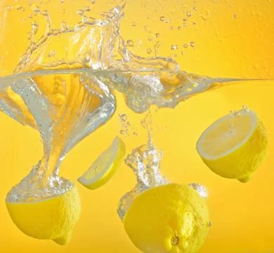 Lemon thrown into the water with splash Stock Photos