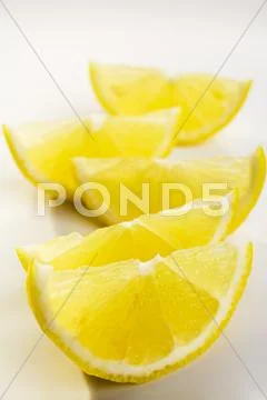 Lemon wedges Stock Photos