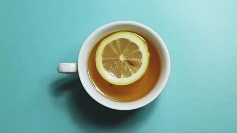 Lemon whirling in a white cup of tea Stock Footage 150918833