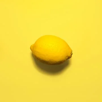 Lemon on a yellow background Stock Photos
