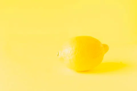 Lemon on yellow background Stock Photos