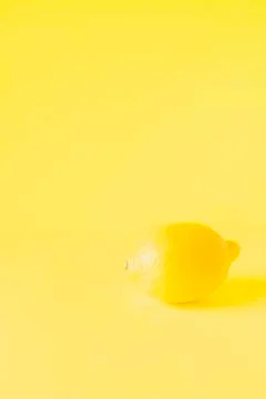 Lemon on yellow background Stock Photos