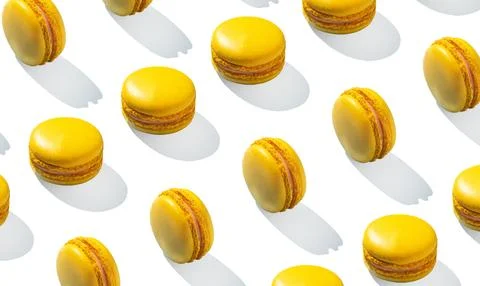 Lemon yellow macarons pattern on white background isolated with hard shadows 스톡 사진