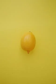 Lemon on a yellow Stock Photos