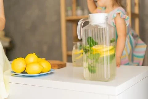 Lemonade on the background of a jug of lemonade Stock Photos