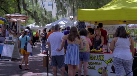Lemonade booth with shoppers gathering Stock Footage 66379319