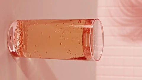 Lemonade bubbling in a glass while gas rises and creates bubbles Stock Footage 339592759