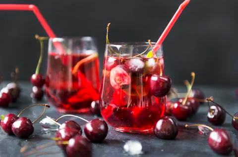 Lemonade with cherries on black background Foto stock