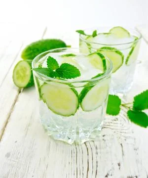 Lemonade with cucumber and mint on light board Stock Photos