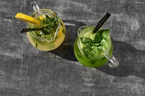 Lemonade with cucumbers, lemons and mint leafs in glasses on wooden table Stock Photos