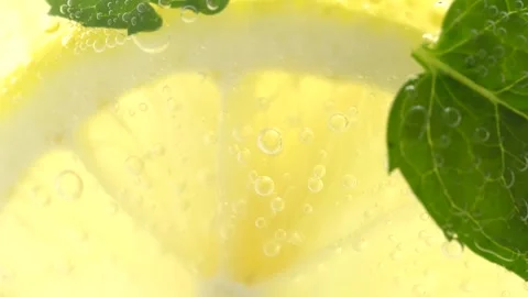 Lemonade in a glass, macro. Fruit lemon cocktail close-up texture, healthy .. Stock Footage 252069680
