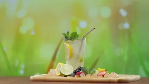 Lemonade Glass on Table Outside Green Blurry Background Nature Natural Refreshme Vídeo Stock 153207250
