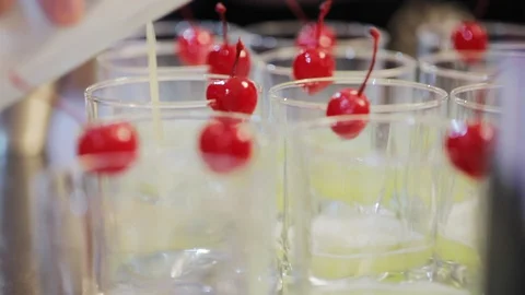 Lemonade in glasses with red sweet cherry Stock Footage 128988089