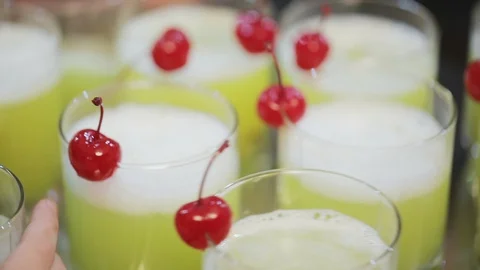 Lemonade in glasses with red sweet cherry Stock Footage 128988094