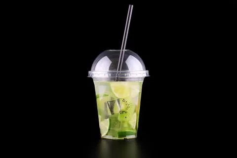 Lemonade to go cup with mint, lime and kiwi on black background, isolated Foto stock