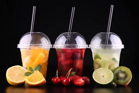 Lemonade to go. Three cups with mint, cherry, strawberry, kiwi, lime, orage, Stock Photos
