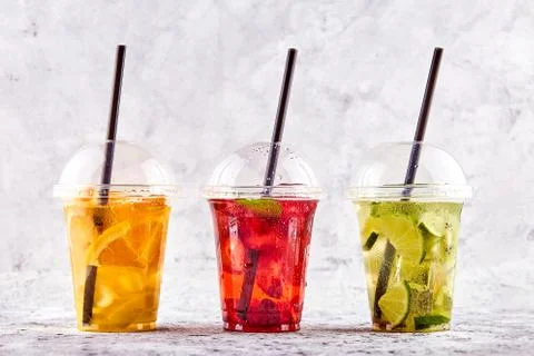 Lemonade to go. Three cups with mint, cherry, strawberry, kiwi, lime, orage, Stock Photos