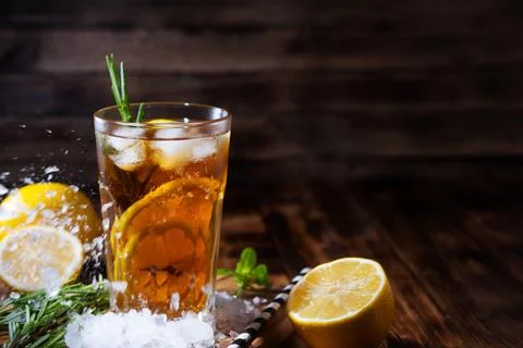 Lemonade with ice and mint on old wooden boards. Ice tea with lemon and lime  Stock Photos