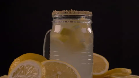 Lemonade in Jar and Lemons Rotating Video stock 130978326