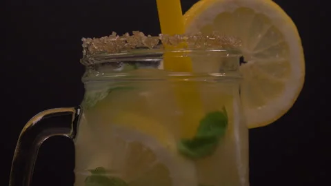 Lemonade Jar with Mint Stirring with Straw and Rotating 4K 스톡 동영상 130985004