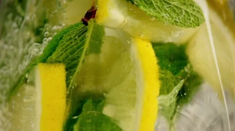 Lemonade with lemon and lime pouring in slow motion Stock Footage 54466858