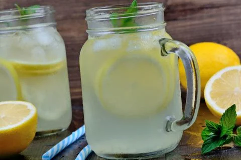 Lemonade with mint in mason jars on table Stock Photos