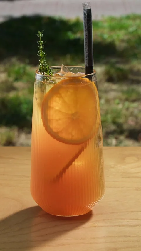 Lemonade with oranges. Summer soft drink in a glass with sliced fresh orange and Stock Footage 314464039